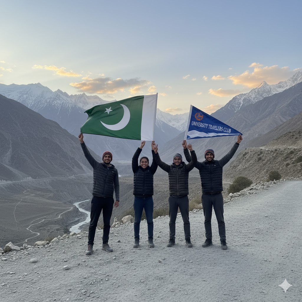 College travelers raising flags at Babusar Top with mountain range behind